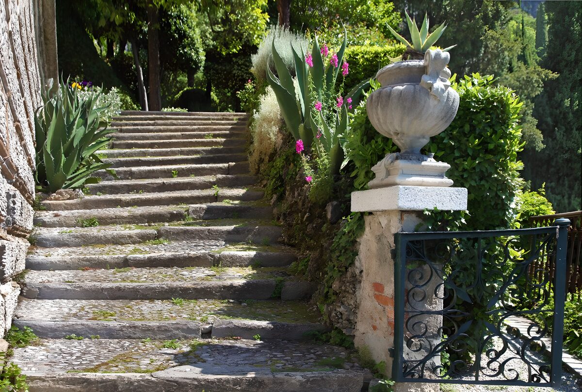 Sonnige Steintreppe im grünen Garten