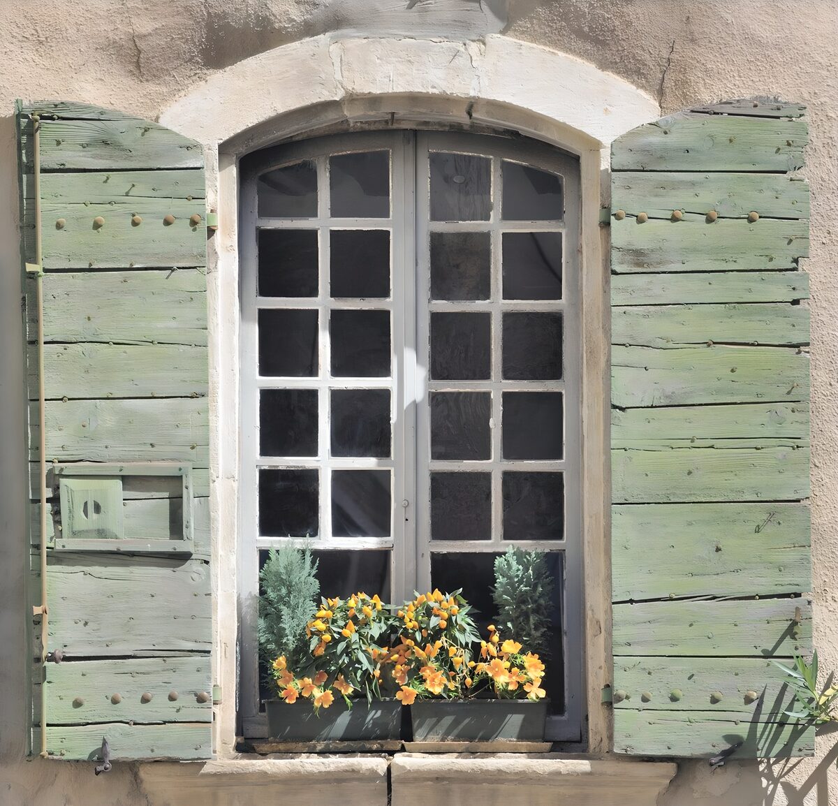 Rundbogenfenster mit üppigem Blumenschmuck