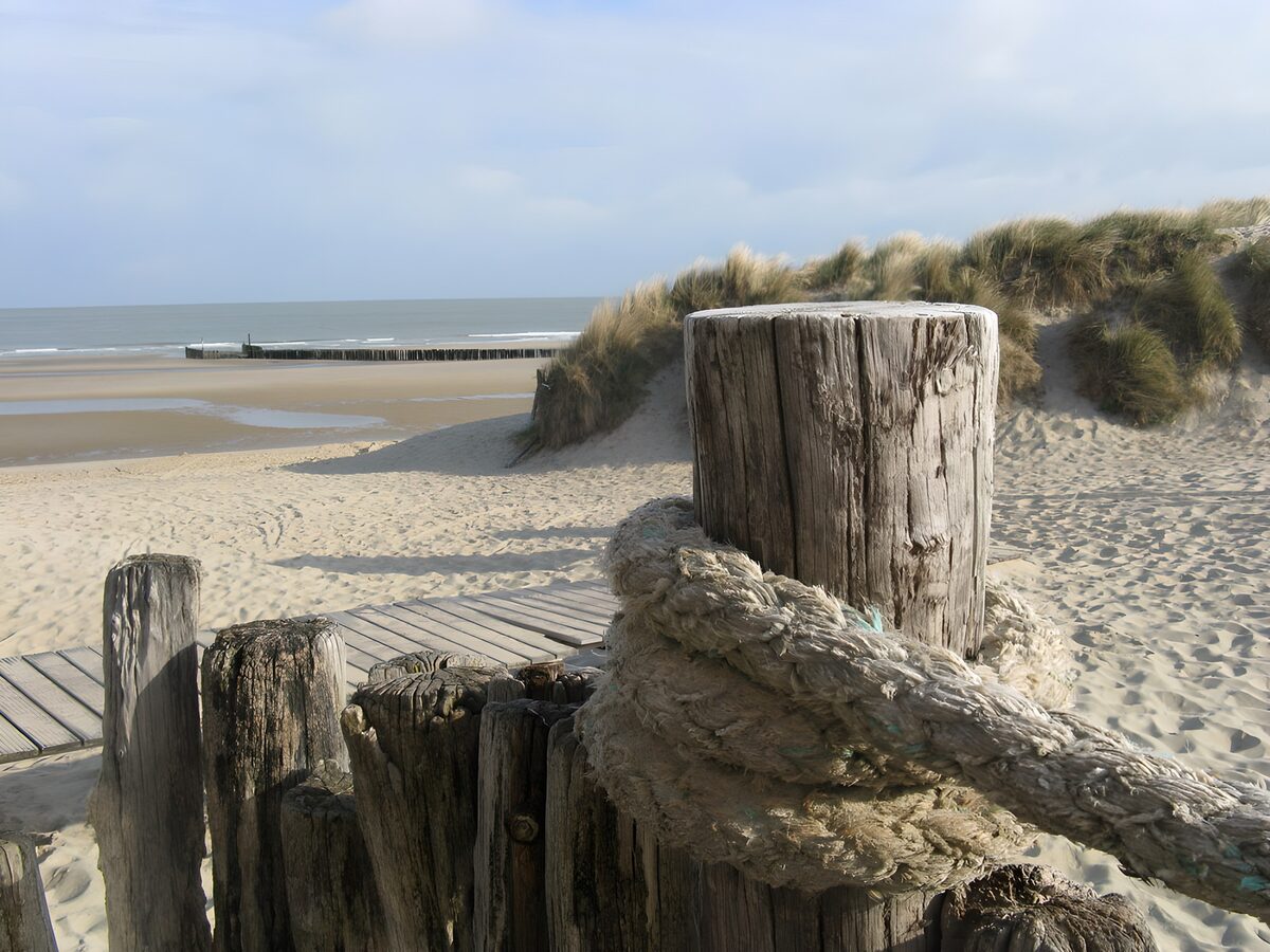 Holzpfosten und Taue am stillen Strand