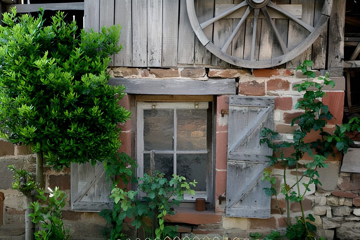 Rustikales Fenster unter dem Wagenrad