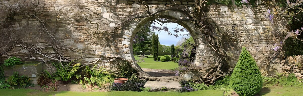 Runder Steinbogen mit Blick ins Gartengrün