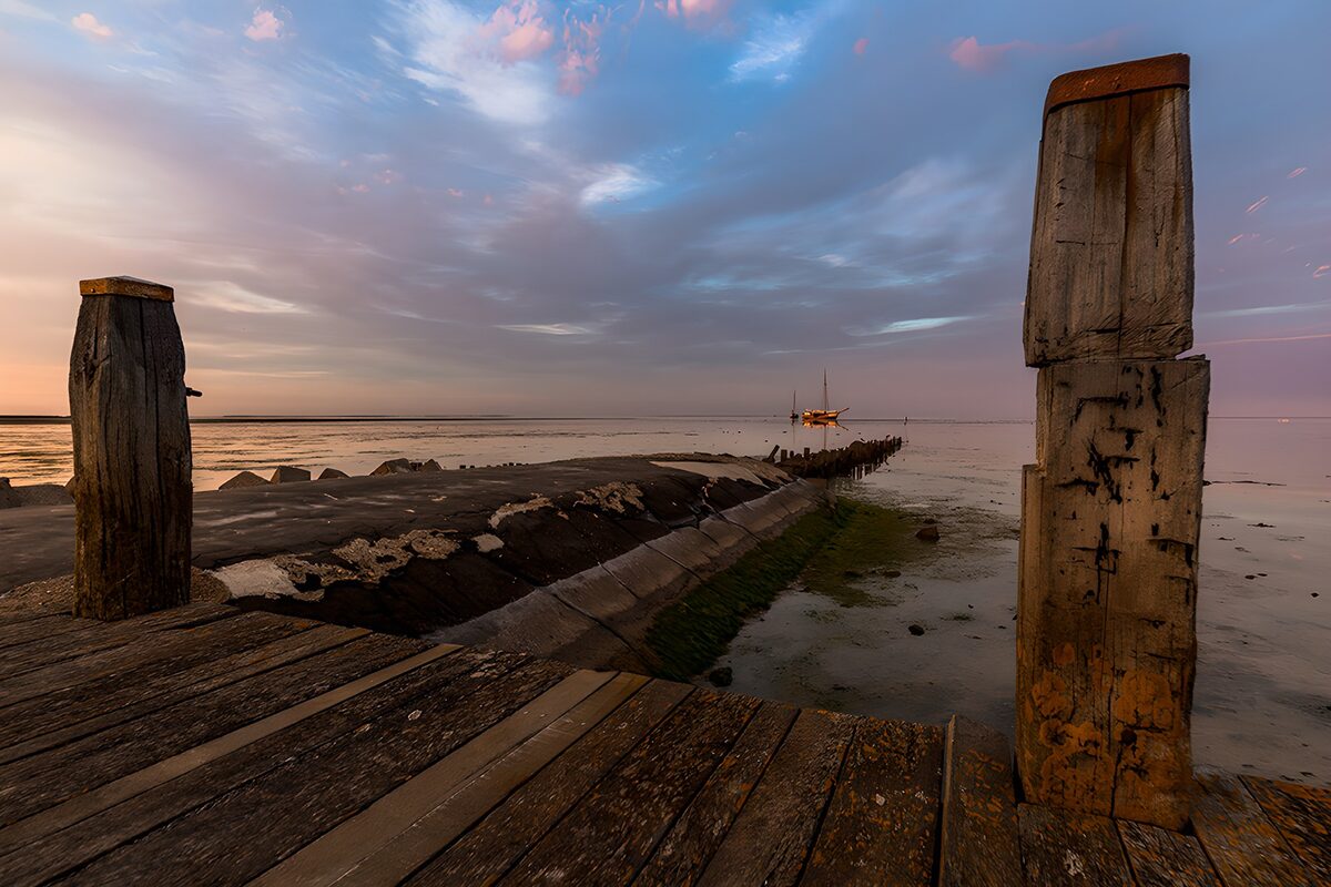 Holzsteg bei Ebbe im Abendlicht