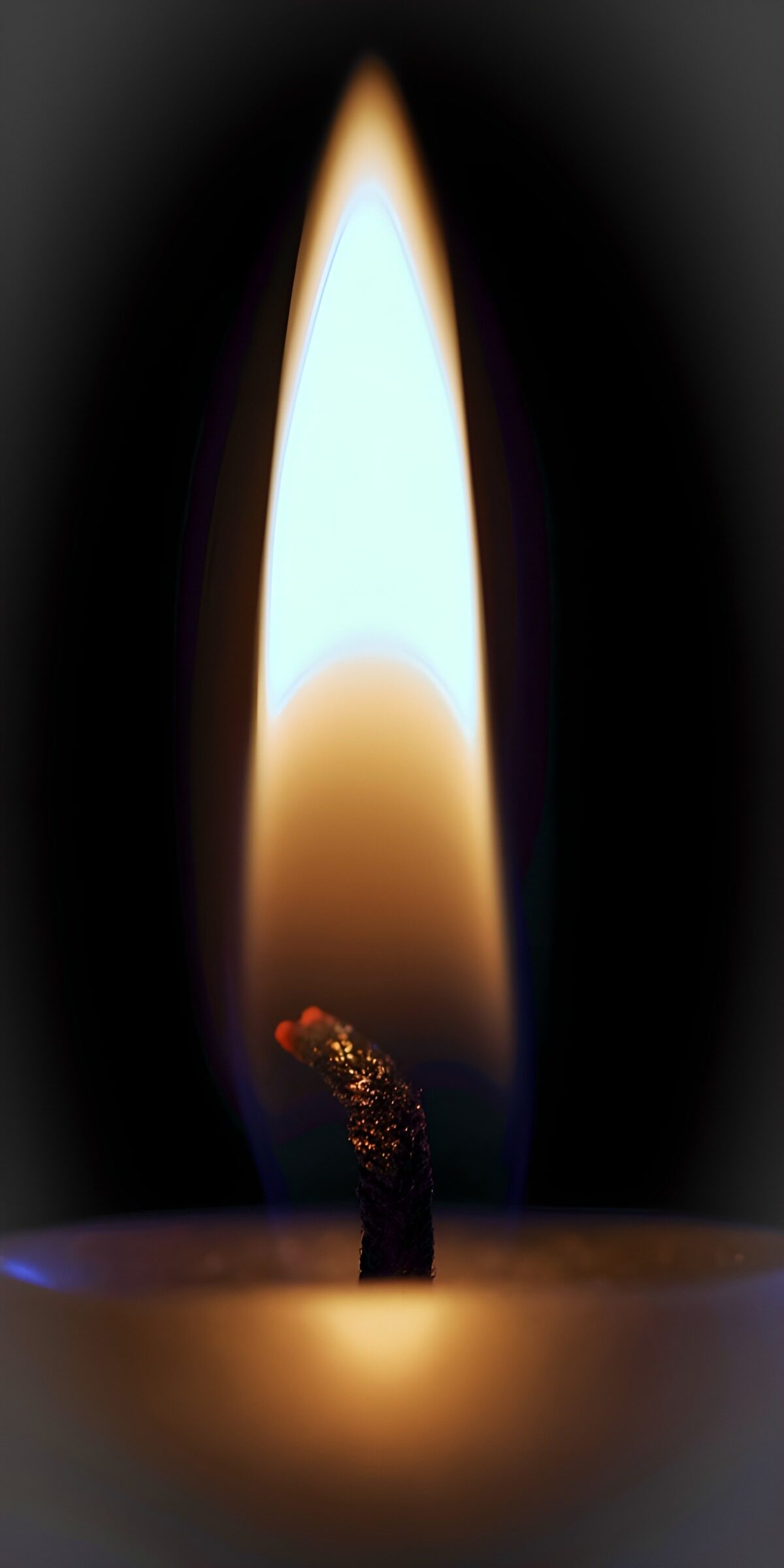 Kerzenflamme vor schwarzem Hintergrund